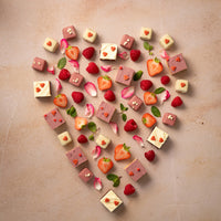 Love Brownie Bites en halve brownies in de vorm van een hart op een roze achtergrond